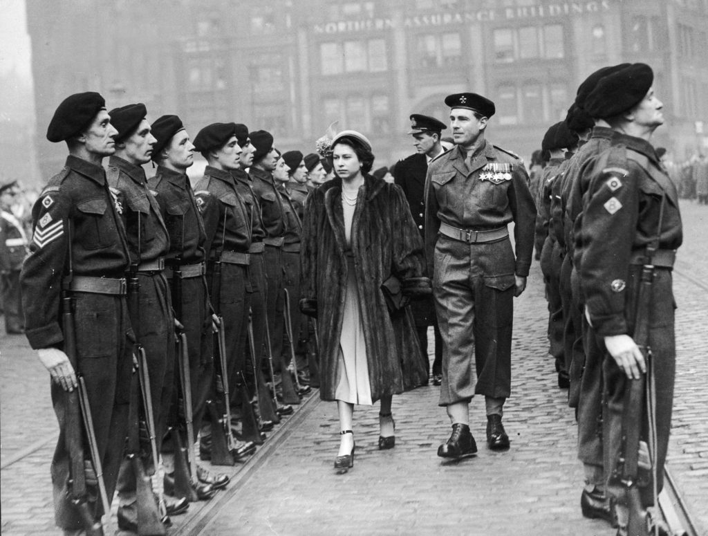 Princess Elizabeth conducts an inspection of the guard in Albert Square Manchester, led by Col R.D Martin Bird. In the background in the Duke of Edinburgh.    30th March 1949. - Source: Around Manchester in the 1950s, iNostalgia Publishing / Mirrorpix