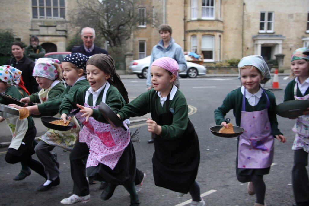 school children taking part in pancake race