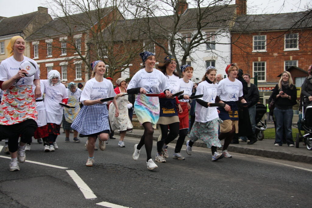 adults taking part in pancake race