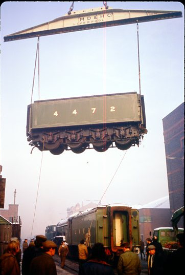 The auxiliary water tender being lifted. A Mersey Docks & Harbour Board diesel is already attached awaiting to move Flying Scotsman to the exchange sidings where a BR loco will complete the move to Edge Hill Motive Power Depot. (C M Whitehouse/Collection Clive Hardy).